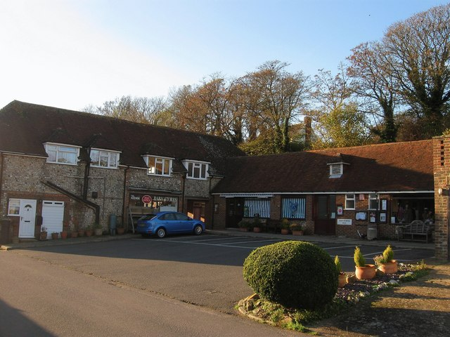 MabelReviewsGB's tweet photo. A loaf revealed East Dean, East Sussex’s working heart.

I nearly stayed by the green, then crossed the main road for bread. Barn Stores looked modest, but the little run of doors and passage beside it changed the visit: this was not scenery arranged for walkers. It was somewhere residents could still do an ordinary, useful errand.

That is the village character worth protecting-everyday shops and services close to homes, not just a view people drive through to admire.