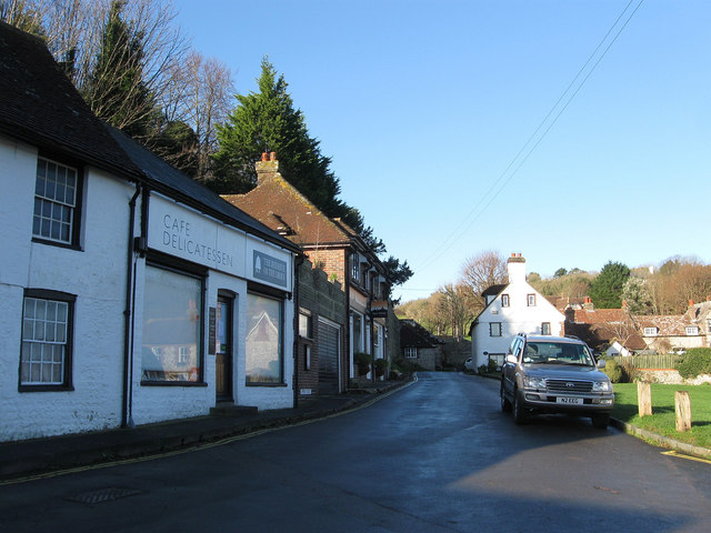 MabelReviewsGB's tweet photo. A loaf revealed East Dean, East Sussex’s working heart.

I nearly stayed by the green, then crossed the main road for bread. Barn Stores looked modest, but the little run of doors and passage beside it changed the visit: this was not scenery arranged for walkers. It was somewhere residents could still do an ordinary, useful errand.

That is the village character worth protecting-everyday shops and services close to homes, not just a view people drive through to admire.