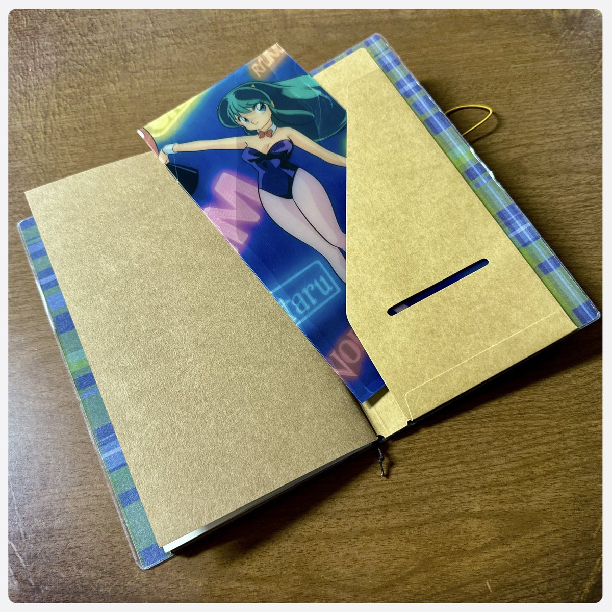 dashiellclipp's tweet photo. Yesterday’s project was using my scrapbook papers to create a #TravelersNotebook for my WIP. I picked up the official repair kit & inserts, plus some contact paper, and じゃーん!Then I took an old 下敷き of Lum that was peeling and cut it down to size for support. Not bad… #トラベラーズノート