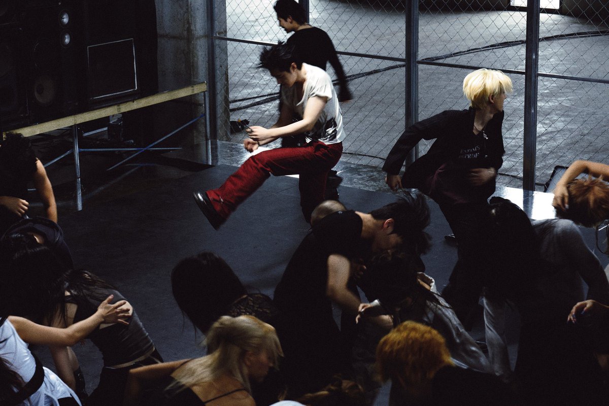 Sunnhoon's tweet photo. Caught in the middle of the noise, where every movement feels like pure adrenaline. Bound by wire fences, moving to our own rhythm, and leaving all control at the door. It’s unscripted, fast, and completely free. https://t.co/ThI8GNciGr