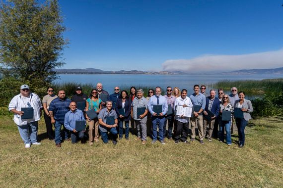 California agencies and Tribes pose by Clear Lake.