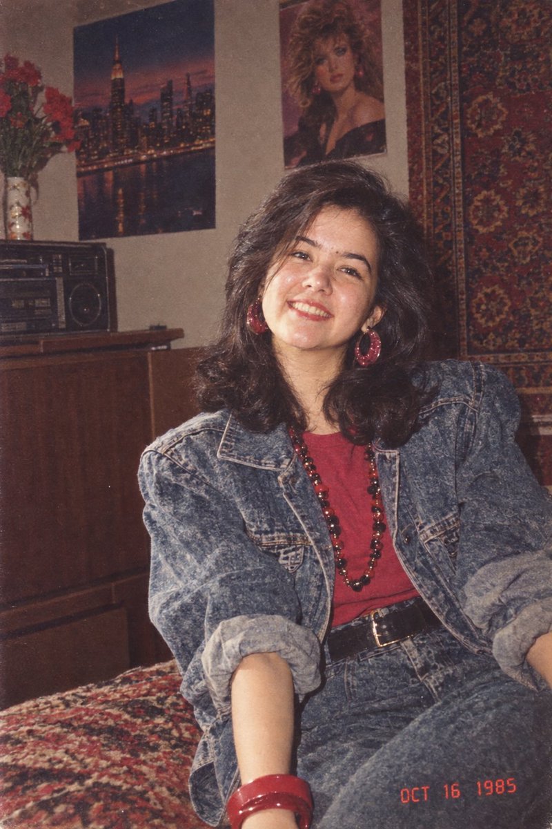 yuldasheva_f's tweet photo. Using my uploaded photo, show me what I would have looked like around 1985. Preserve my identity, facial features, skin tone, age, and recognizable appearance.  Reimagine my hair, clothing, accessories, and surroundings with bold, unmistakably mid-1980s styling… (1)👇 https://t.co/b4vKMDLMGM