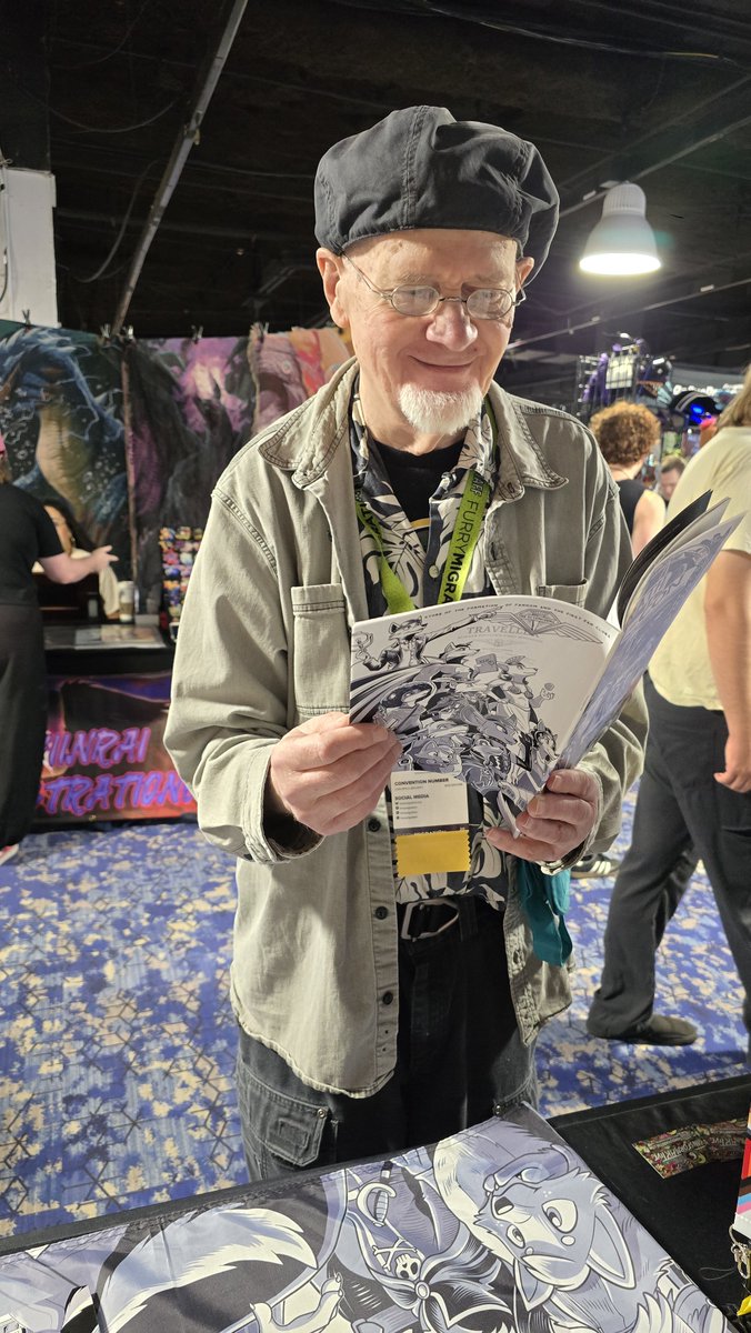 ConHistory's tweet photo. Delighted Ken Fletcher was given a copy of my Wrath of Con comic and dropped by to chat about fan history. Co-founders of the APA Vootie, considered one of the many origin points of furry fandom. Funny the week before at Worldcon saw he was one of the Rotsler Award winners. https://t.co/Hpwxsqpi6l