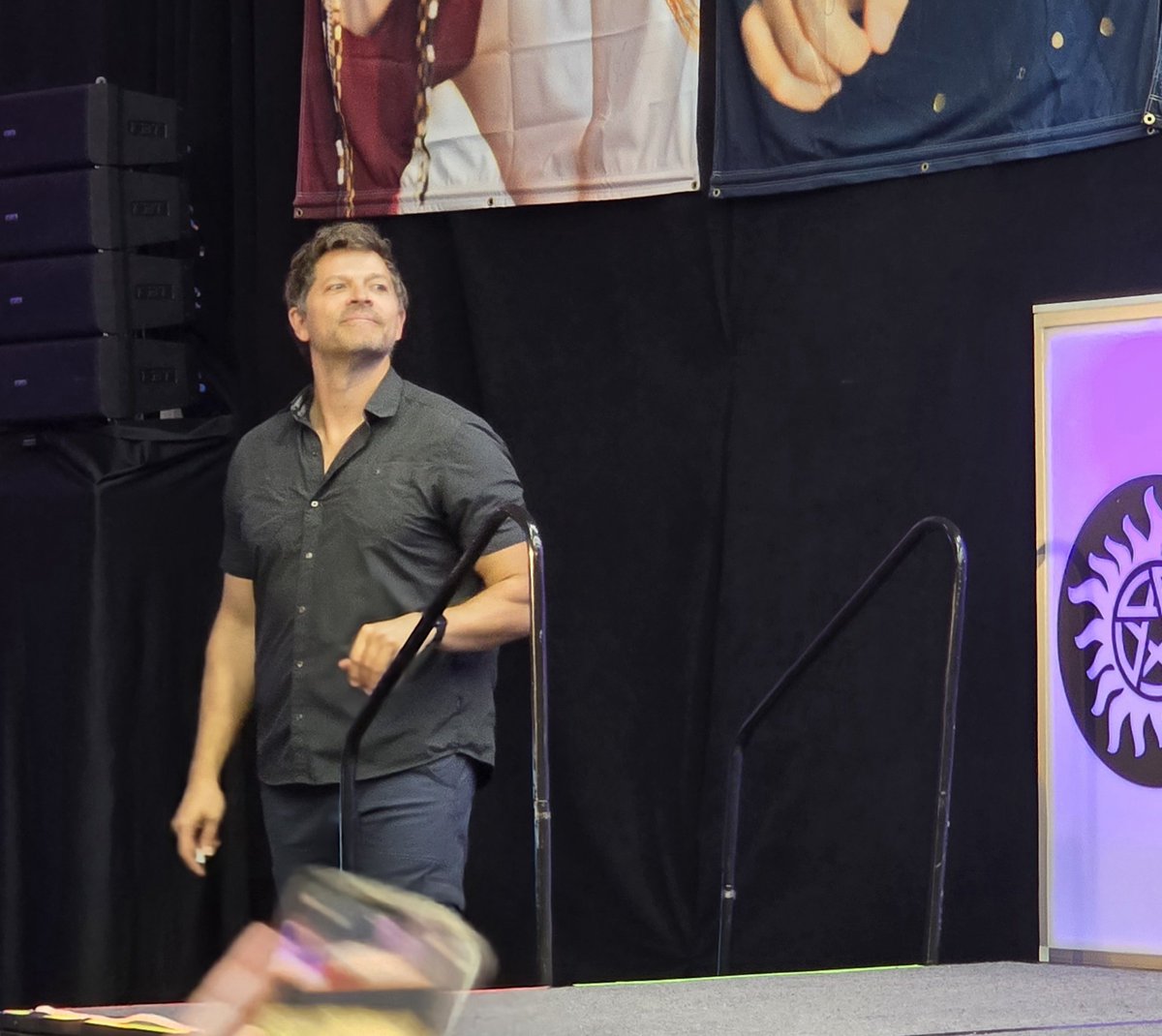 FangasmSPN's tweet photo. .@mishacollins listens to @adamfergus describe his first experience of fanfic with his character and Castiel  #SPNORL https://t.co/f1UB4NEmBv