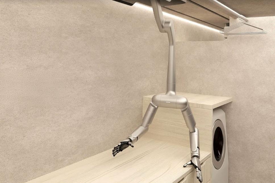vigram_void's tweet photo. Tokyo startup MW unveiled a wonderfully contrarian approach to domestic robotics: robotic arms built directly into houses, traveling along ceiling-mounted rails rather than walking around on legs. In demonstrations, the system moved groceries, sorted food between pantry and refrigerator, handled laundry and folded a towel; MW wants its first robot-equipped homes on sale in Tokyo in 2028 and eventually targets 10,000 homes annually by 2035.

The company has raised roughly ¥3 billion (~$20M) so far.

I think this idea deserves far more attention than it will probably get.

Humanoids solve an extraordinarily difficult constraint:

Make the robot adapt to an environment designed for humans.

MW flips the problem:

Make the environment adapt to the robot.

A ceiling rail eliminates locomotion, stairs, balance and much of collision avoidance while supplying permanent power and known coordinates.

That could make a $20k fixed manipulator dramatically more useful than a $100k humanoid for many homes.

It's essentially the smart-home concept taken to its logical conclusion: the building itself becomes a robot.