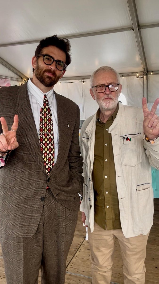 jeremycorbyn's tweet photo. Great to meet my friend Hasan Piker at Manifiesta, a festival organised by the Belgian Workers Party.

Hasan is still banned from the UK - an absurd decision that must be reversed, now.

Well done to Hasan for refusing to be quiet in the face of genocide &amp; apartheid! https://t.co/DadLMCbXyq