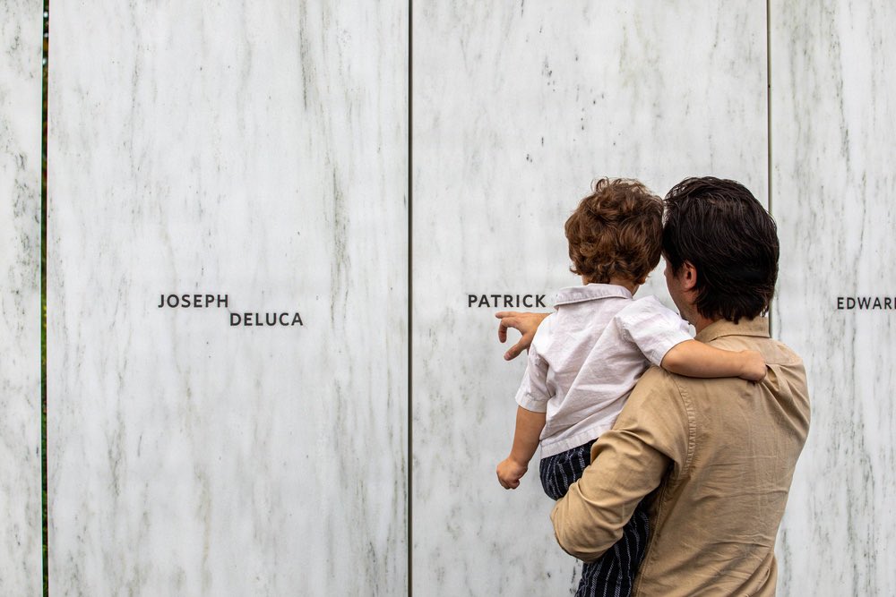 ByIndigoDom's tweet photo. Ryan Gould, 33, right, and Whitney Gould, 2, his son, pay tribute to Patrick Joseph Driscoll, Ryan’s grandfather, during the 25th anniversary memorial ceremony at the Flight 93 National Memorial, near Shanksville, Pennsylvania, Sept. 11, 2026. 
Shot by me 🩷 https://t.co/aB6lHJA5Hi