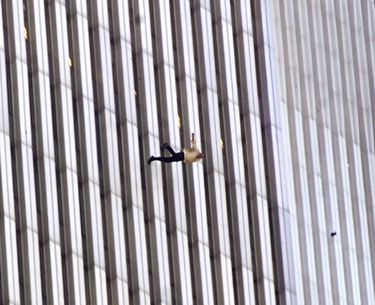ChristianHeiens's tweet photo. The infamous “Falling Man” is actually one shot in a series of photos that were taken in a row.

In some ways, the second photo is almost more eerie than the more famous shot of him tumbling upside down, because the falling man is almost directly looking at the photographer. https://t.co/oyqr3mOw5W