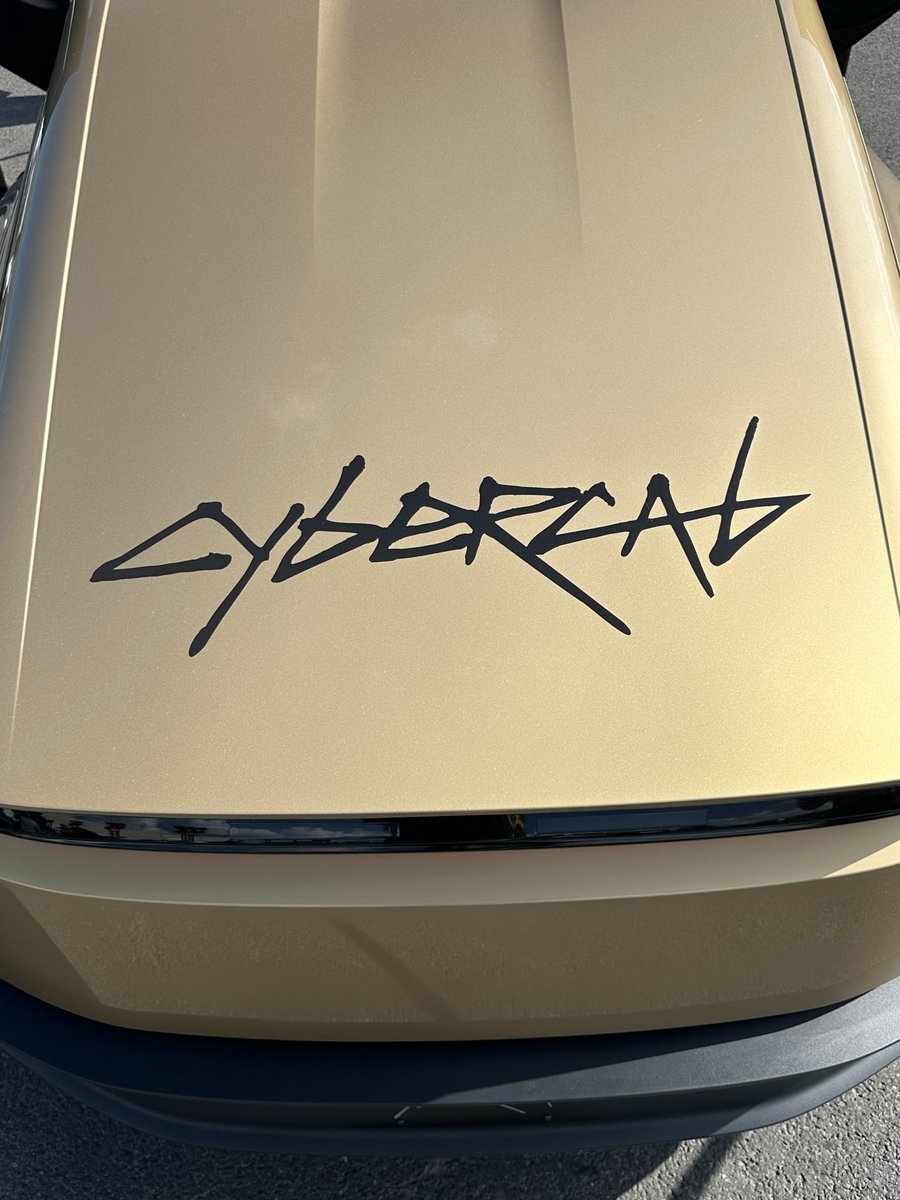 Roosie__'s tweet photo. Gold Cybercab at the Giga Brandenburg Summer Games.

Didn’t expect to walk past this today. The gold looks different in the sun than it does in pictures, and that CYBERCAB lettering on the hood is looks so cool! 

Doors up, people crowding around it, factory in the background. Still strange seeing it sitting here instead of on a screen.
Inside it’s almost empty compared to a normal car. Big screen, bench seats, no steering wheel on this one. 

Kids were more interested in the doors than anything else - Fair enough.

Pretty cool they actually brought one out for the event.

#tesla #cybercab #Ai #taxi #gold #goldenera #TSLA #germany #brandenburg #Future #autonomy