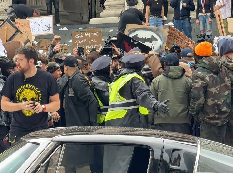TheBatmanFilm_'s tweet photo. Multiple protest signs have been spotted on the set of ‘THE BATMAN 2’ 🦇

• “Court of Fowls”
• “I'm coming for you next”
• “Your Greed is Killing Us”
• “Oligarchs gotta go”
• “The richer get richer”
• “Eat the rich”
• “One day the poor will have nothing”
• “Gotham is _____ for justice”
• “Re$i$t”