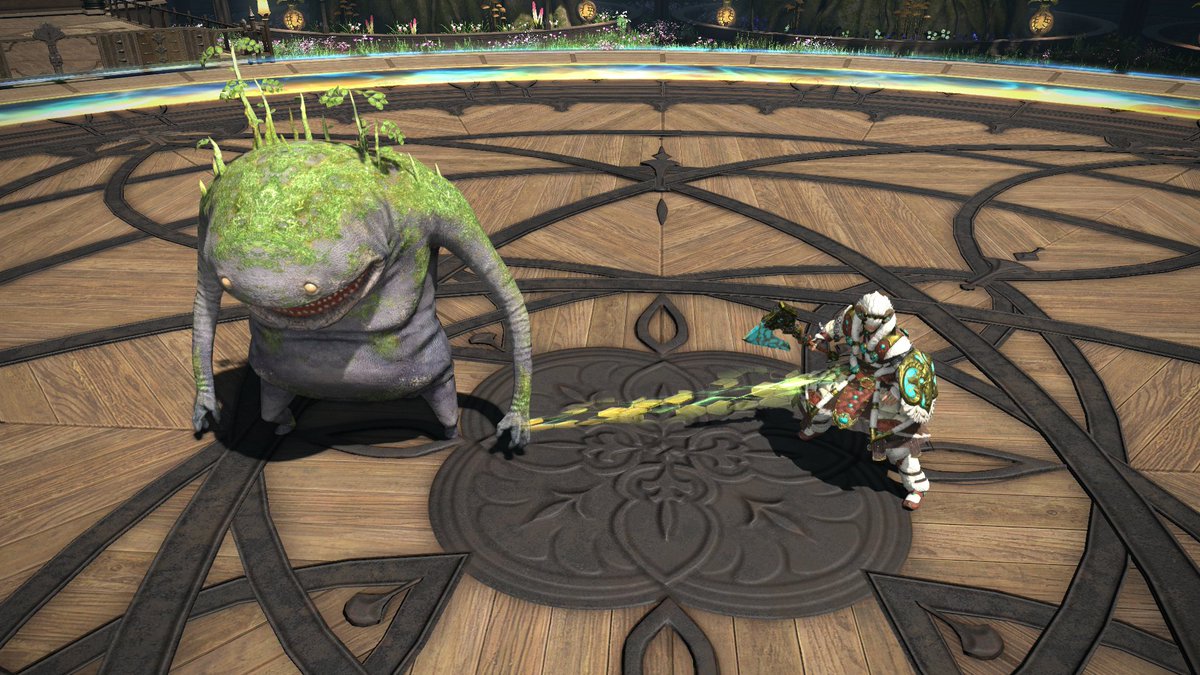 A screenshot from Final Fantasy 14 of a beastmaster tethered to their goobbue familiar while standing in a circular arena.