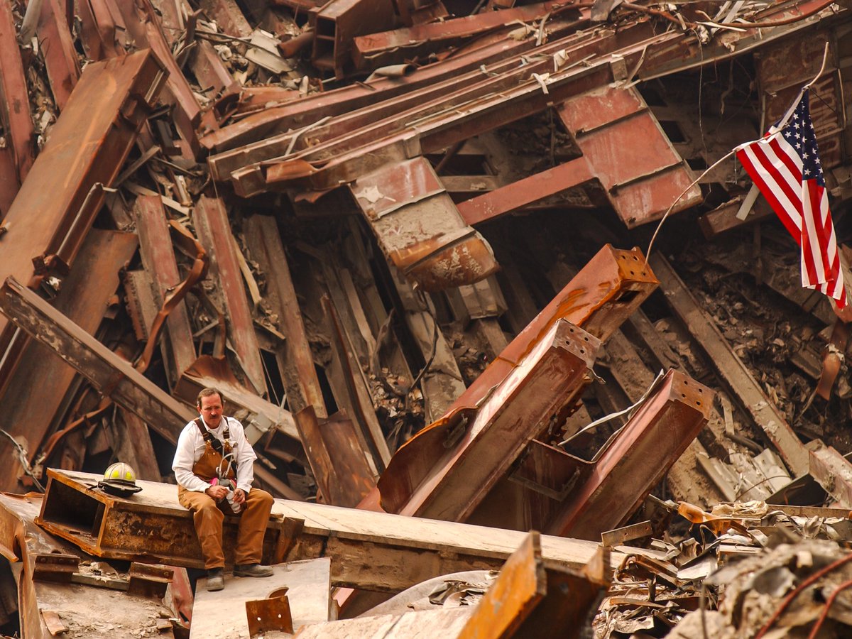 kadonkey's tweet photo. A lone NYC firefighter sits amidst the destruction of the World Trade Center Sept 2001. (a. booher/fema) https://t.co/TfiC7RvgCg