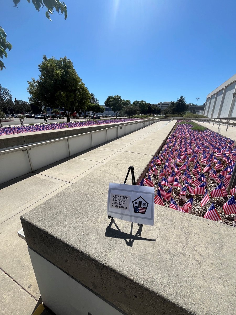 FBILosAngeles's tweet photo. During the week leading up to the 25th anniversary of 9/11, employees at FBI Los Angeles took part in a Memorial Stair Climb to honor the firefighters who climbed the World Trade Center stairwells during the attacks, as well as a Walk of Honor, to honor the lives of those lost on 9/11.  Walk of Honor participants collectively completed 2,977 laps around the federal building in West Los Angeles for each life lost on 9/11 and carried a flag in their honor.  #WalkOfHonor #911Anniversary