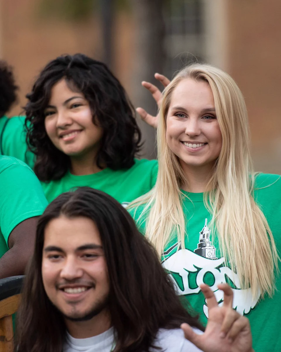 Students smiling on campus.