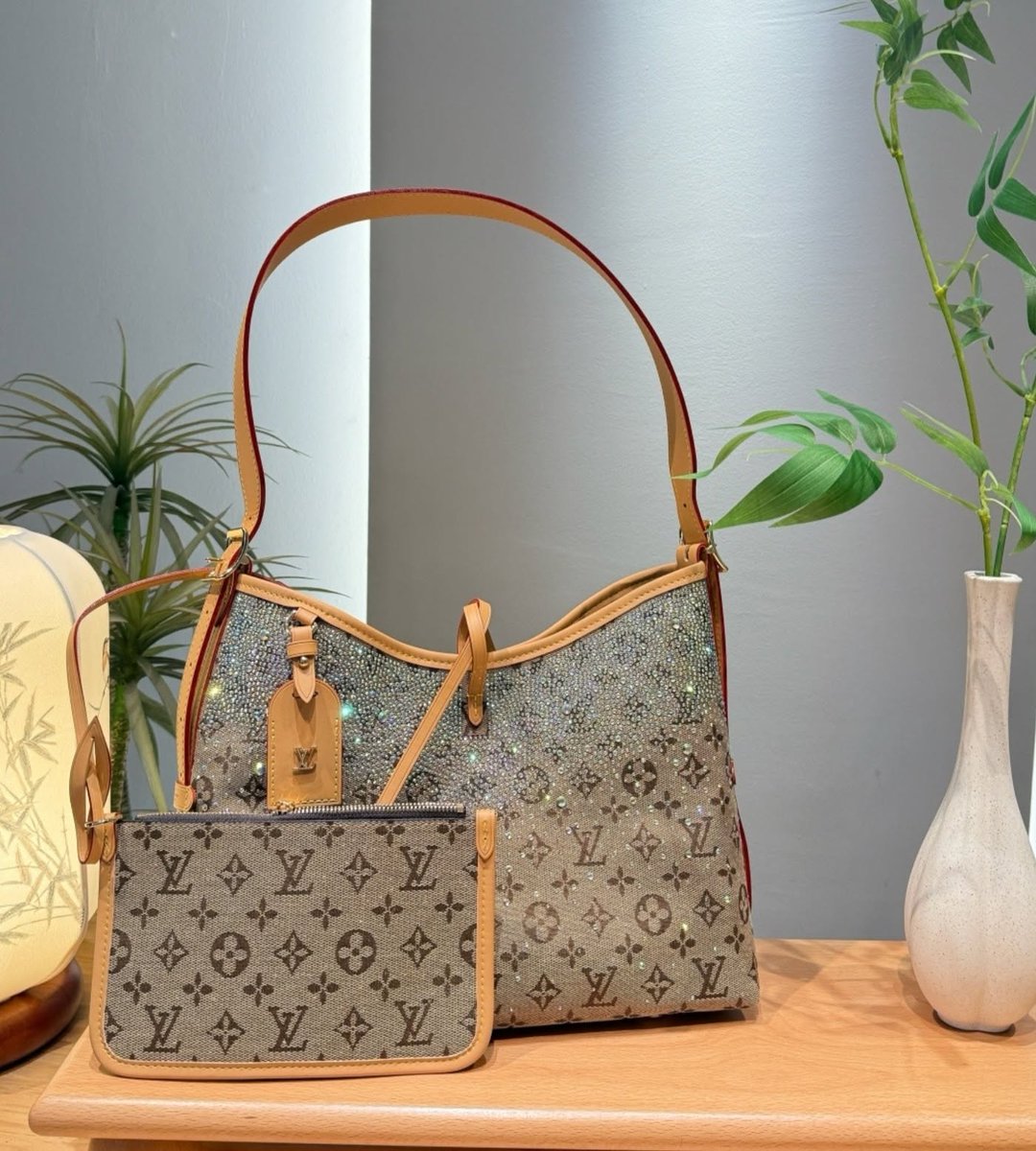 Romulo_adan's tweet photo. Meet the LV CarryAll with a dazzling twist: a relaxed hobo in black monogram canvas, embellished with iridescent crystals. Complete with a matching pouch and adjustable strap. Also available in darker and lighter brown. Which colorway is your https://t.co/1QYcTWyFYZ