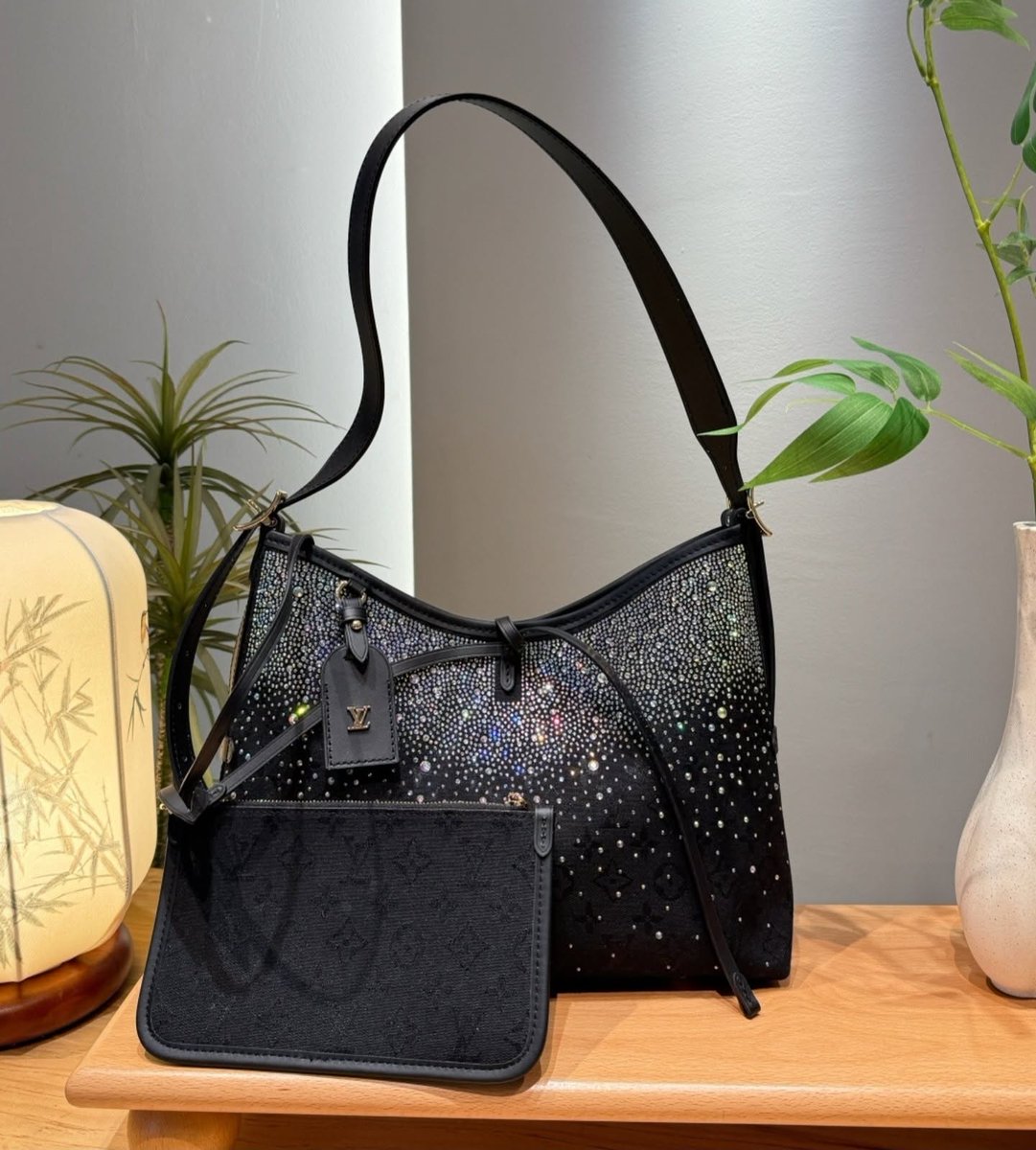 Romulo_adan's tweet photo. Meet the LV CarryAll with a dazzling twist: a relaxed hobo in black monogram canvas, embellished with iridescent crystals. Complete with a matching pouch and adjustable strap. Also available in darker and lighter brown. Which colorway is your https://t.co/1QYcTWyFYZ