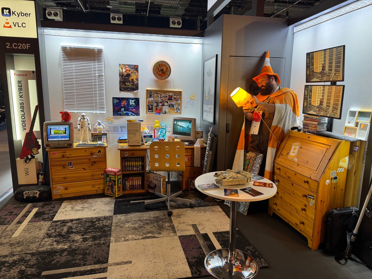 videolan's tweet photo. "Play Cyberpunk 2077 on a Pentium III from 1999" 
Our crazy demo and our 90s teenagers room booth won the best of the show award at @IBCShow 

Yes, Cyberpunk is fully playbable on the PIII and on the CRT screen through @Kyber_tech with extremely low latency.
Yes, this is a booth in a normal tradeshow :)

Love to @CDPROJEKTRED