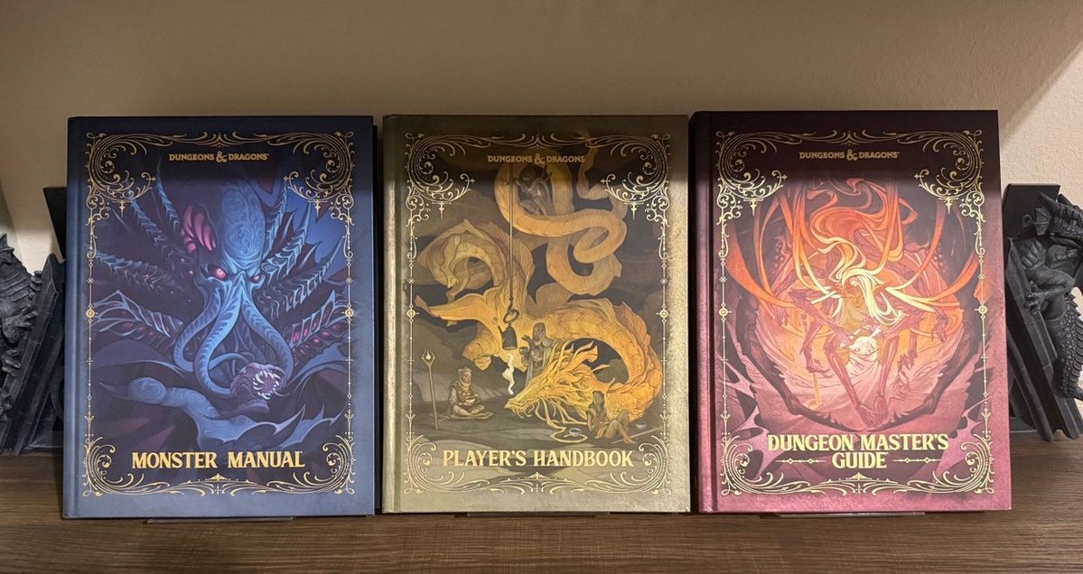 RoleWise's tweet photo. ...lookie at Mikes new neato pieces..
Firmly cementing himself as our "Dungeons and Dragons Guy."
..and also I believe he's ethically obligated to run a 5.5e game for us now.

They are pretty books for sure...and a lovely display.  More nifty things to share int he future! https://t.co/CqiZBZYz7c