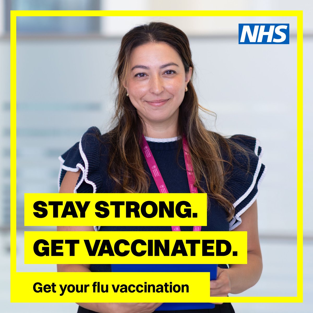Smiling NHS worker encouraging flu vaccination with message to stay strong and get vaccinated.