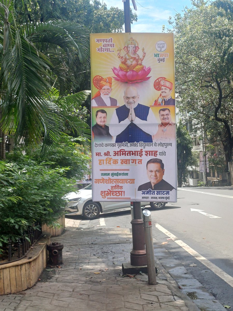 pervinsanghvi's tweet photo. Welcome to BJP's Mumbai. Where the purpose of a footpath is not for pedestrians to stay safe but to string political banners from. 
This is not only a sickening show of power and arrogance but also, flouting of a court order. @AshwiniBhide, "Pedestrian First"???! https://t.co/9MZz3ark5I