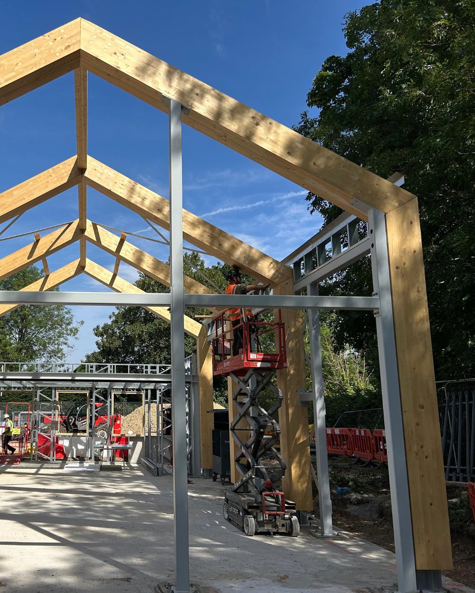 BucklandTimber's tweet photo. Bookham Youth &amp; Community Centre taking shape - Spruce GL28 #glulam frame working alongside the steel framing system, is now in place. Proud to have manufactured and installed the #glulam as part of the wider project team. Beard_Construct #HPWArchitecture #AWAConsultingEngineers https://t.co/fb2HpvUpu6