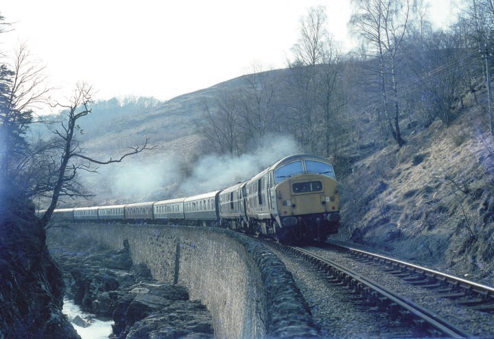 CrecyRail's tweet photo. In April 1968, the evening service from Fort William to King’s Cross in the Monessie Gorge, has blue livered
Class 29 No D6129 piloting  green liveried classmate D6124. Within three years these North British built diesels would have been withdrawn.  https://t.co/4LwKd4u7xf https://t.co/uUZjbxtXOb