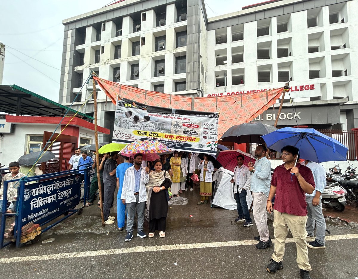 UKresidentsdocs's tweet photo. DAY 8 | BRAVING THE RAIN, STANDING FIRM: THE STRUGGLE CONTINUES AT DOON HOSPITAL GATE! 🩺🌧️✊

​As our indefinite strike enters Day 8, the resident doctors of Uttarakhand refuse to bend. Today, under heavy rain at the main gate of Government Doon Medical College Hospital in the state capital, Dehradun, hundreds of residents stood shoulder to shoulder, raising an unshakeable voice for our basic rights.
​8 continuous days of protest, OPD shutdown, and struggle yet the Government of Uttarakhand remains completely indifferent. Let the authorities know: verbal assurances mean nothing anymore. We will not move an inch without a formal, written Government Order (GO) for stipend parity.

​We urgently appeal to all national and state medical associations, senior faculty, IMA, and doctors across India: this is the hour to step forward and show absolute medical fraternity unity.
​Hon'ble CM Shri @pushkardhami ji & @ukcmo, your doctors are braving rain and streets for justice. Issue the written GO immediately!
​#Day8Strike #UttarakhandDoctorsStrike #RainProtest #CandleMarchTomorrow #StipendHikeNow #DoonRDA @jpnadda @subodhuniyal1  #HaldwaniRDA #SrinagarMedicalCollege #AlmoraRDA #FairStipend #DoctorsUnited @Uttarakhand_News @MoHFW_INDIA @drakashhchauhan @drabhijeetRathi @FordaIndia @FAIMA_INDIA_