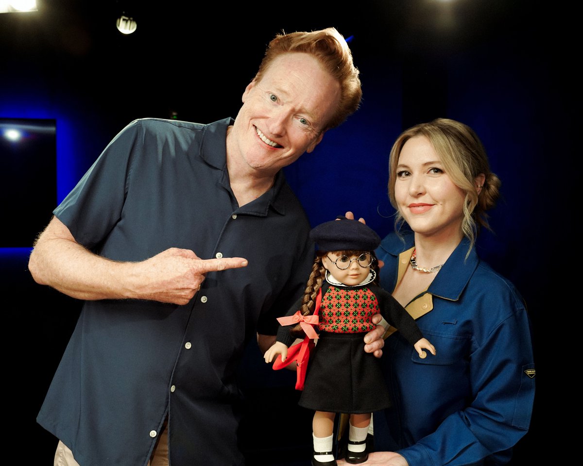 ConanOBrien's tweet photo. Years ago I surprised Taylor Tomlinson with her first American Girl doll. This week she returns the favor. https://t.co/MhtsEaJS9S https://t.co/lxZVfyTsOA