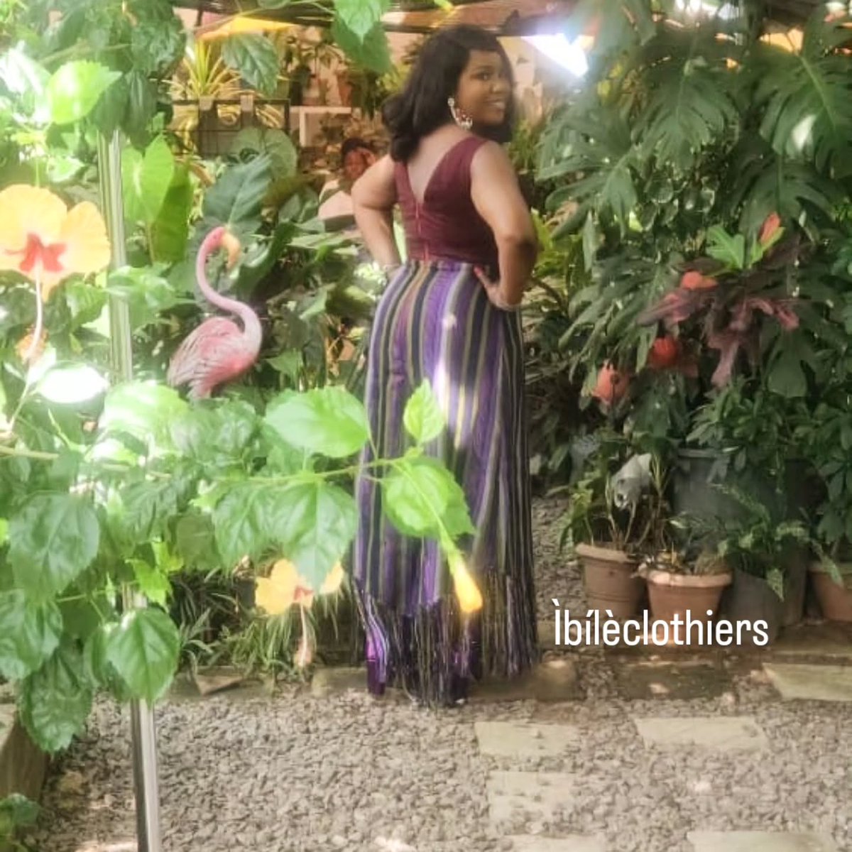 DaMicaelly's tweet photo. ÀJÒ ÌRÈTÍ represents a hopeful journey shaped by confidence, purpose and tradition. This sleeveless A-line dress combines striped and plain burgundy Aṣọ-Oke, symbolising distinct paths moving in harmony. https://t.co/ClE71j1E3b
