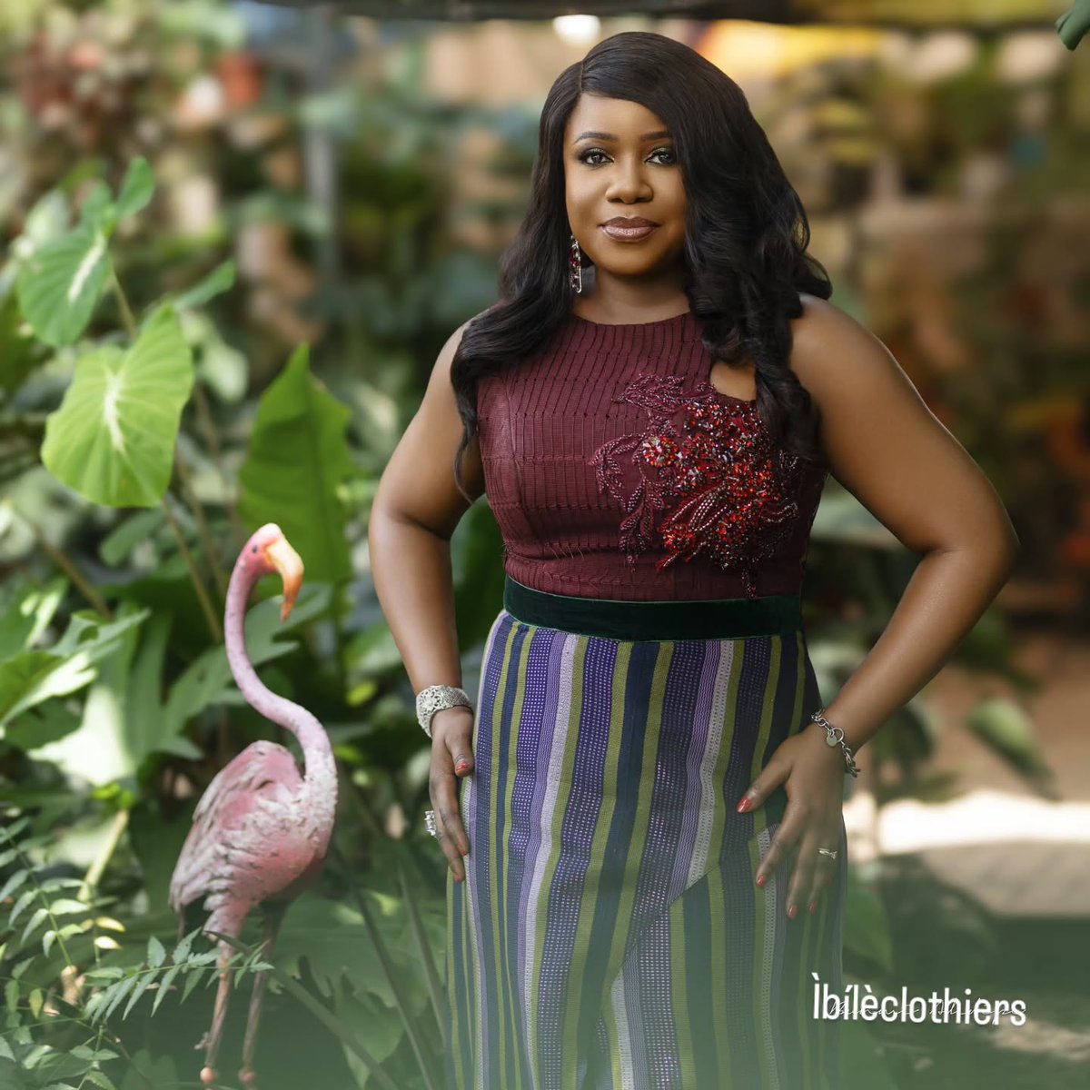 DaMicaelly's tweet photo. ÀJÒ ÌRÈTÍ represents a hopeful journey shaped by confidence, purpose and tradition. This sleeveless A-line dress combines striped and plain burgundy Aṣọ-Oke, symbolising distinct paths moving in harmony. https://t.co/ClE71j1E3b