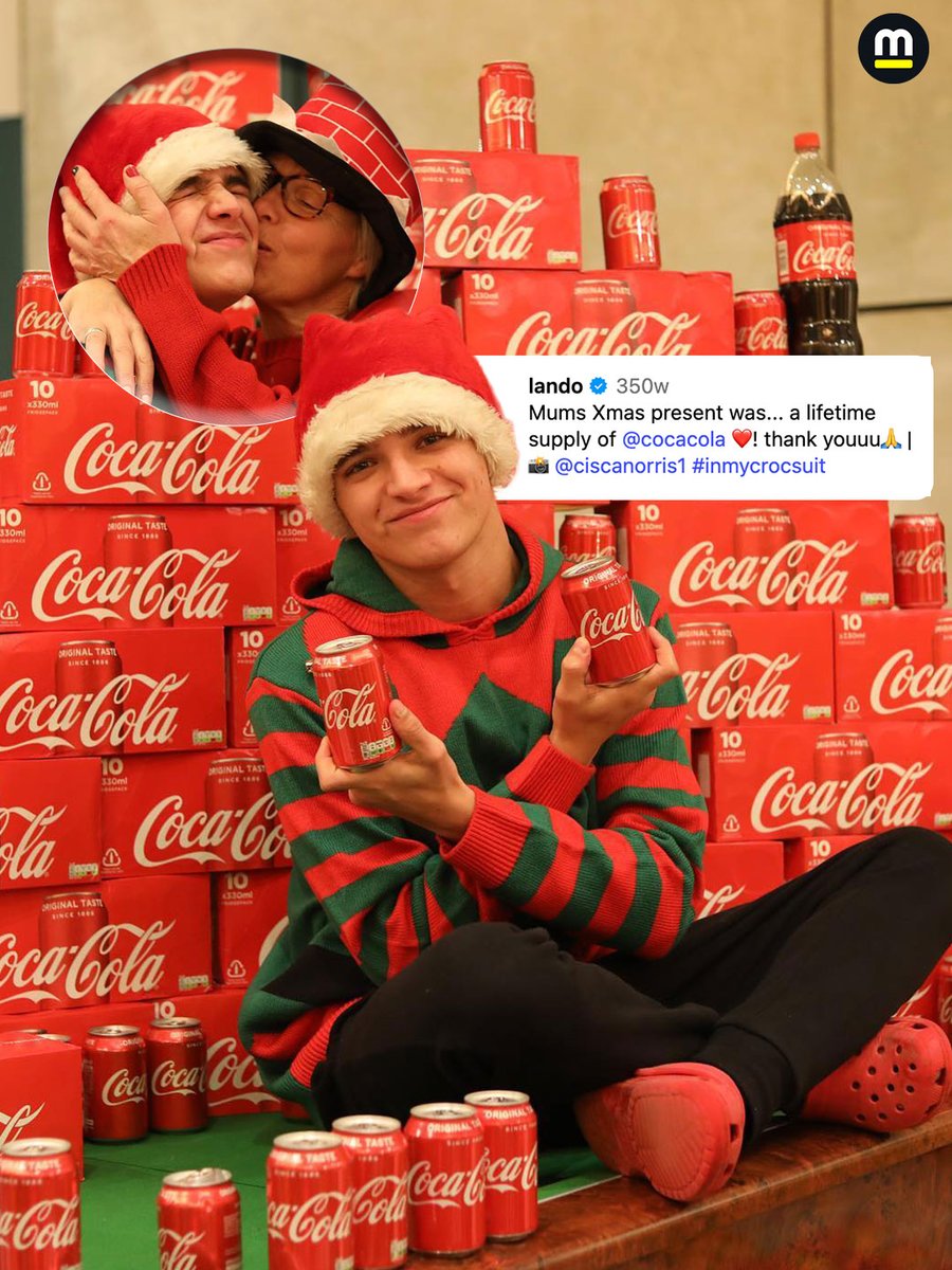 Lando Norris posing with a bunch of Coca-Cola cans on Christmas in 2019. His caption was "mums Xmas present was... a lifetime supply of Coca-Cola."