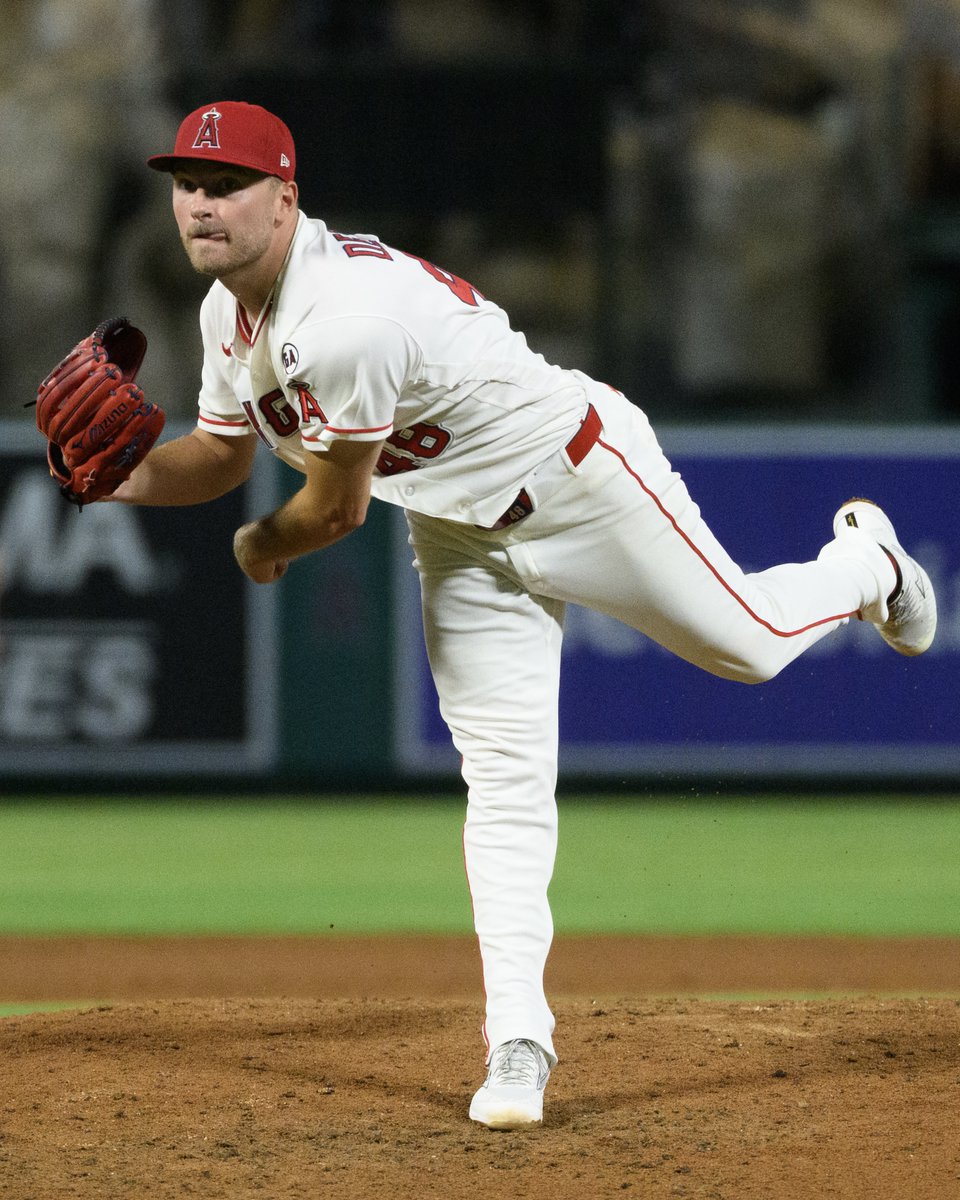 Reid Detmers sticks his tongue out as he delivers a pitch in his start against the Mariners.