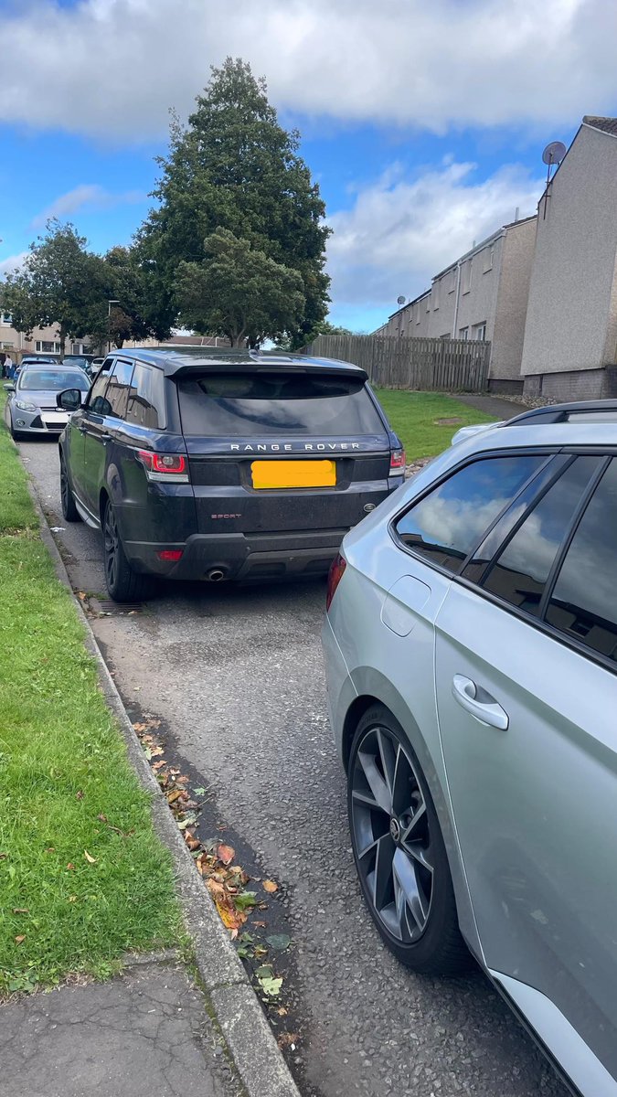 Black coloured vehicle and unmarked Police patrol vehicle