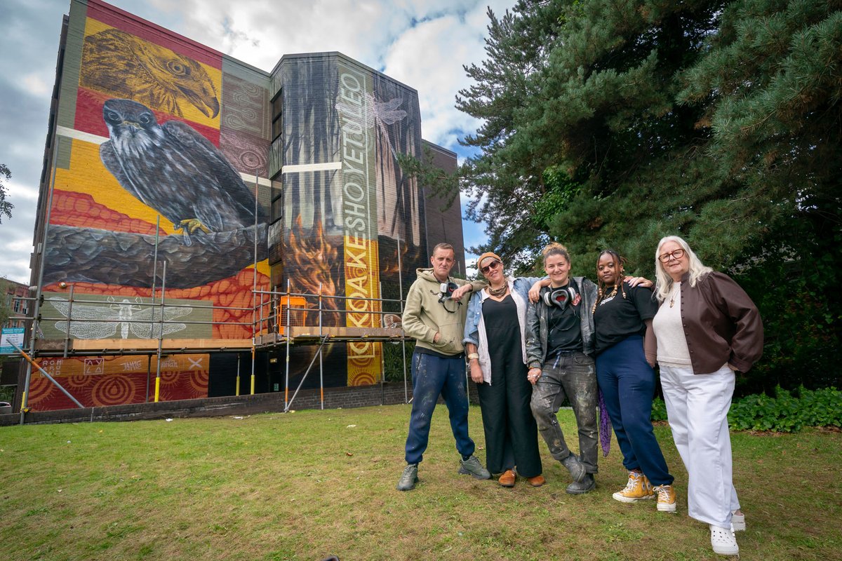 Councillor Sue Smith (right) with the artists putting the finishing touches to the mural at Brook House, Middleton.