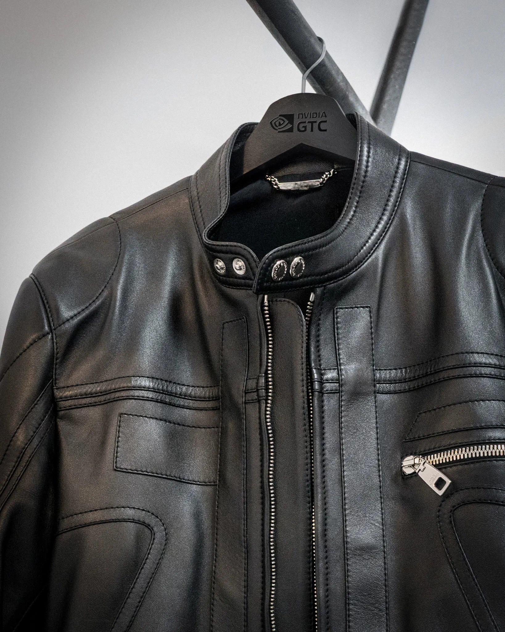 Black leather jacket on NVIDIA GTC hanger with zipper detail.