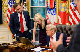 JBThinkin's tweet photo. Here me out this. We all know trump is a moron, weak and easily persuaded. He can’t resist someone who blindly agrees with him, especially a woman.
So that begs the question we ALL should be asking…

Is Natalie Harp a PLANT?

The speculation surrounding Natalie Harp, trump's executive assistant, stems from her unique and highly influential role within the White House.
The primary reasons she has recently become the subject of national security discussions which include:
•Security Clearance Delays: In August 2026, reports revealed that Harp had been working in the White House for over a year without a completed formal security clearance. She reportedly delayed submitting the necessary federal background investigation forms. This caused significant concern among ethics watchdogs and intelligence officials, given her proximity to classified information.

•The "Intelligence Nightmare" Warning: National security experts, including former CIA operative Marc Polymeropoulos, have publicly warned that Harp's gatekeeper role makes her a primary target for foreign adversarial intelligence. Because she controls much of the media and documentation trump views daily, experts note that foreign intelligence services (like those of Russia or China) would naturally target her for compromise or surveillance. However, this warning was about her vulnerability to foreign actors. But could she actually be working for them?

•Unprecedented Access: Dubbed the "human printer," Harp travels extensively with the president and filters the information that reaches him. Her intense proximity has drawn heavy political scrutiny from Democrats and intense scrutiny from the media.

Of course, The White House and trump's team have strongly defended Harp, stating that she has since completed her forms, holds a standard security clearance, and is a loyal, hard-working member of the administration. But still, knowing what a weak and unintelligent person trump is, is it far fetched to say something smells like a RAT?!
