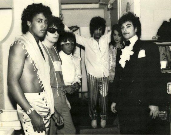 crockpics's tweet photo. Prince gathered backstage with his touring unit during the legendary 1999 Tour between late 1982 and early 1983. Flanked by Brown Mark, Dr. Fink, Dez Dickerson, Lisa Coleman, and Bobby Z, Prince stood in full ruffle-shirt and striped-trouser glory right as 1999 and Little Red Corvette were breaking wide open on MTV and top-40 radio. 

🎸 1999 was Prince's breakthrough double album.  What is your favorite track from that landmark 1982 record? 🎸 👇️