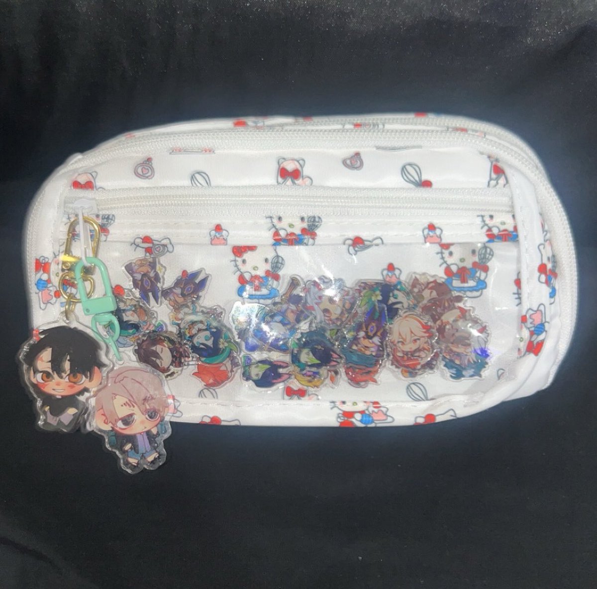 unknown_Kirby's tweet photo. I got a new pencil bag today, I put these lil genshin impact charms I had in it also put #follozan on it 🤤🤤 https://t.co/KeJOI9HYqS