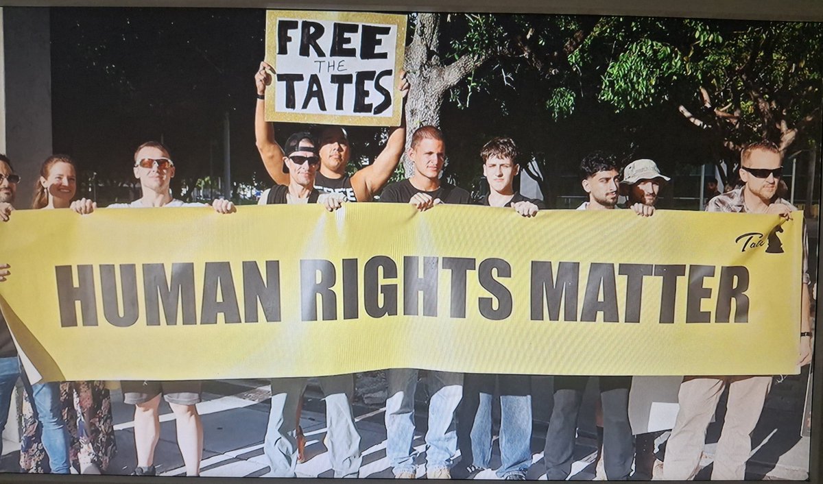 Cat_Magic811's tweet photo. Lol. Look at these fucking mouth breathers.

> The fucking irony of that sign, holy shit. 
#AndrewTate https://t.co/zb5rHLdBs5
