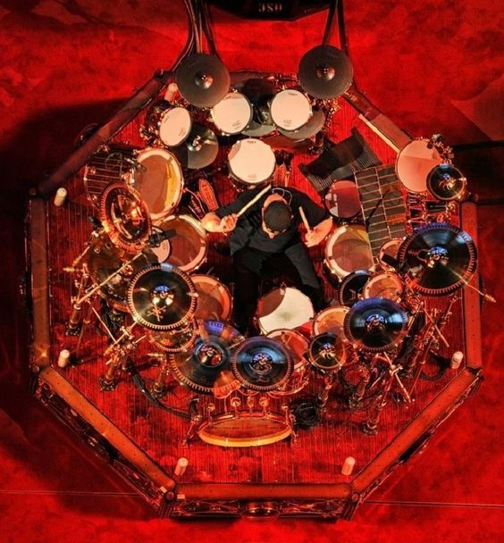 crockpics's tweet photo. Neil Peart seated inside his massive, custom-built Drum Workshop setup during Rush's R40 Live 40th Anniversary Tour in 2015. Captured high above the stage by John Arrowsmith.

🥁 Neil Peart famously referred to his massive 360-degree drum rigs as his command center, requiring immense physical endurance and ambidexterity to navigate. Where does Peart rank on your personal list of the greatest rock drummers of all time? 🥁 👇️
