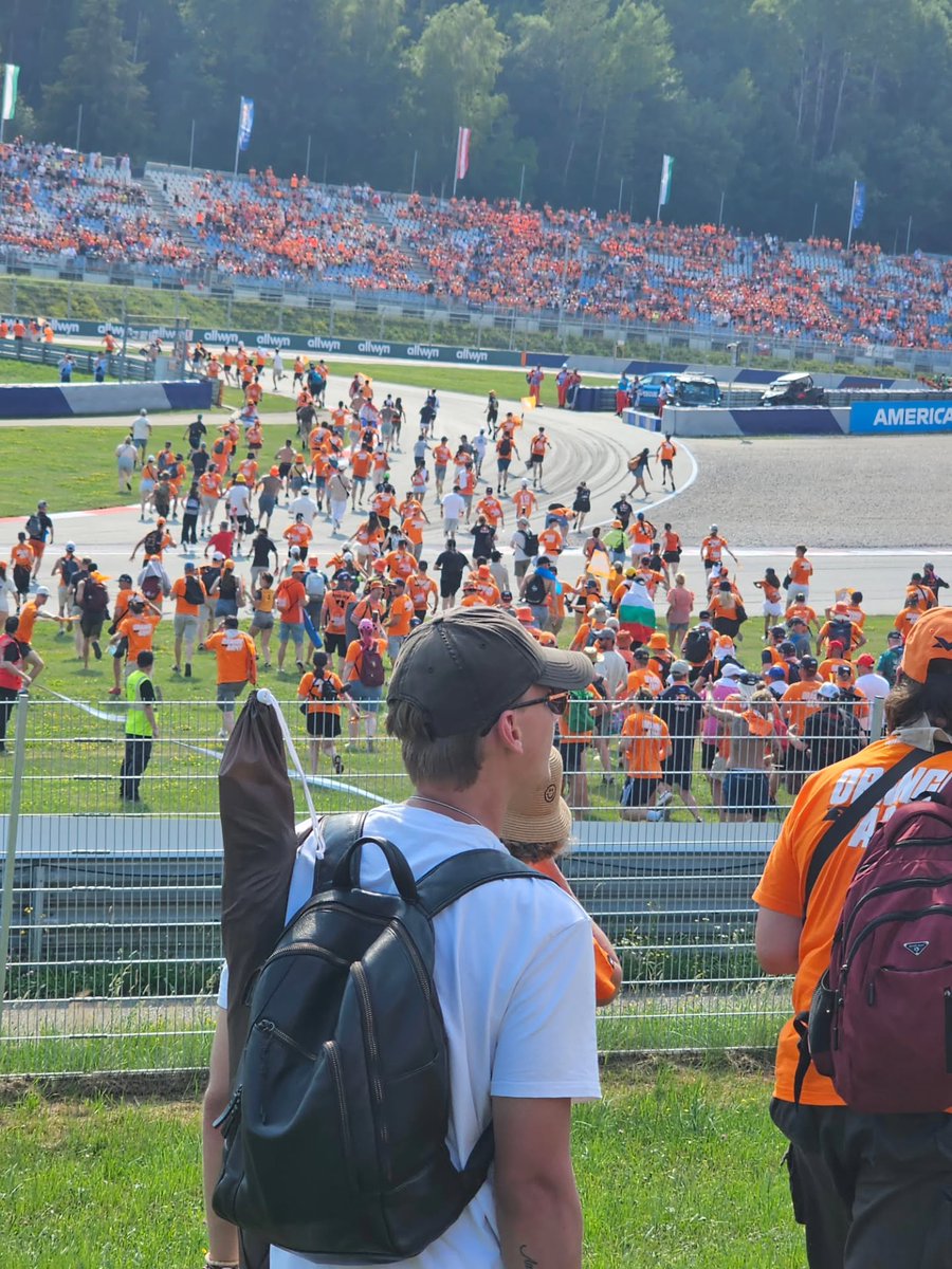HenriettaLrod's tweet photo. Track invasion at the Red Bull Ring. Fans flood the circuit, flags wave everywhere, and the whole place celebrates after the race. Being on the track after the finish is unforgettable. https://t.co/8pZzFJmxcr