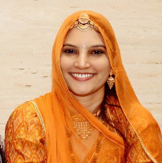 san_x_m's tweet photo. She made a bag by hand and sold it for 70 rupees.

The raw material had cost her 50.

So she had made 20 rupees.

Her name is Ruma Devi.

She was born in 1988 in Rawatsar, a village in Barmer district in Rajasthan. She lost her mother as a small child. Her father remarried.

When she reached class 8 her family took her name off the school rolls and put her to work in the house. Part of that work was walking about 10 km a day to fetch water.

She was married at 17.

Her first son died 48 hours after he was born.

She has spoken about what happened next. In those dark days, she said, she remembered that her grandmother had taught her kashidakari, the traditional embroidery of that region. She picked up a needle again.

That is where the 20 rupees comes in.

She had no sewing machine, so everything was done by hand. She went from house to house in the village asking other women to work with her. Most of them had the same skill. All of them had learnt it from a grandmother.

Ten of them agreed. Each put in 100 rupees. Together that was enough to buy one sewing machine.

That is the entire founding capital of what came next.

Today the network she built covers tens of thousands of women artisans across the villages of the Thar desert. She is president of an organisation called Gramin Vikas Evam Chetna Sansthan and runs a foundation in her own name.

For most of those women it was the first money they had ever earned themselves.

Somewhere along the way, designers came to Barmer for a fashion show. Ruma Devi asked whether she could take part in it.

She was told no. You are supposed to stitch, she was told. Fashion designing and fashion shows are not your forte.

She has since shown at Rajasthan Heritage Week. She has worked with Anita Dongre, Bibi Russell and Abraham Thakore. She has represented Rajasthan in Germany, Singapore and London. She was named Designer of the Year at Textiles Fair India in 2019.

In 2018 the President of India gave her the Nari Shakti Puraskar.

She has an honorary doctorate. Harvard invited her to speak.

She dropped out of school in class 8 because her family removed her name from the register.

The skill she built all of it on was the one thing nobody thought to take away from her, because her grandmother had already given it to her for free.