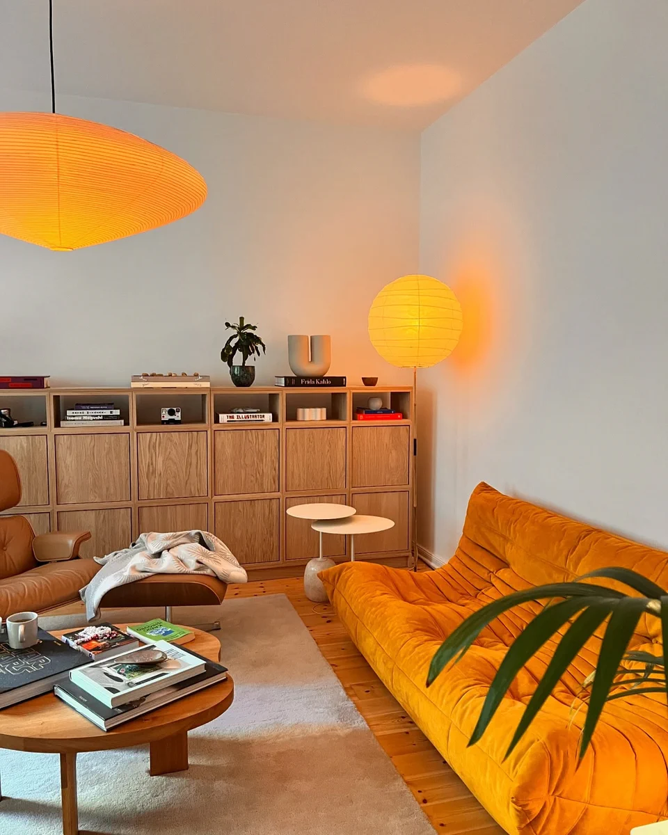 Interior Only on X: "Warm retro-modern living room with a bold orange ...