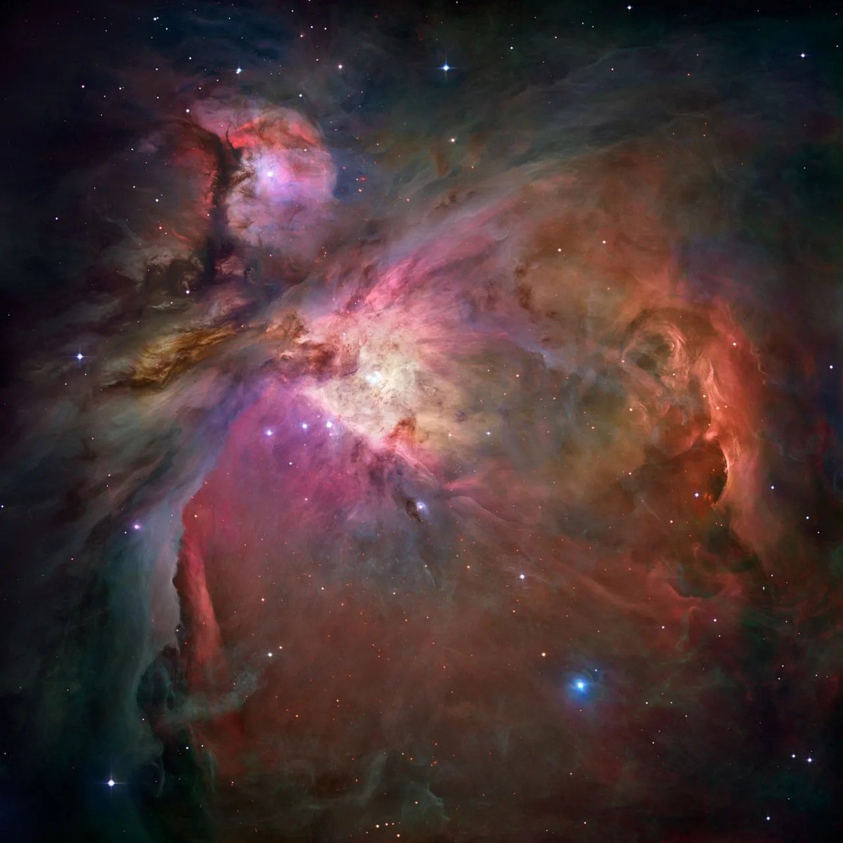Messier 42: A vibrant and colorful image of the Orion Nebula, showcasing swirling clouds of gas and dust in hues of purple, pink, and orange, dotted with bright stars. The nebula is set against a dark cosmic background.