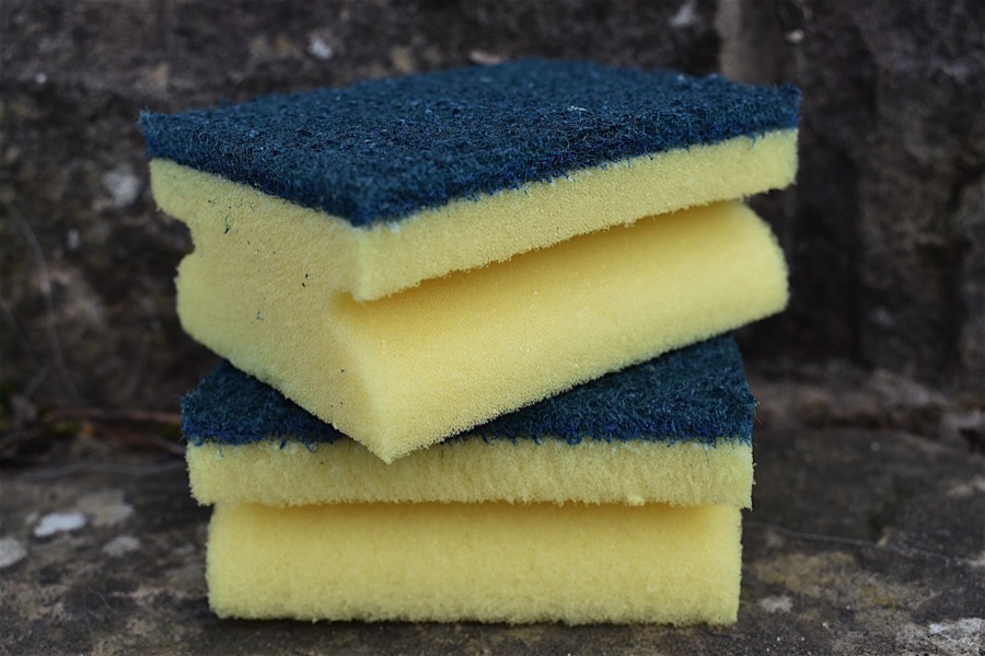 Two yellow and green plastic kitchen sponge scourers
