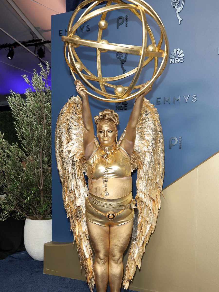 luresmagazine's tweet photo. Meg Stalter turned heads at the 2026 Emmys by showing up fully gilded as a living Emmy statuette alongside Paul W. Downs, delivering one of the most iconic and creative red carpet moments of the night.
#Lures #MegStalter #PaulDowns #Emmys2026 https://t.co/JgatKaFwbz