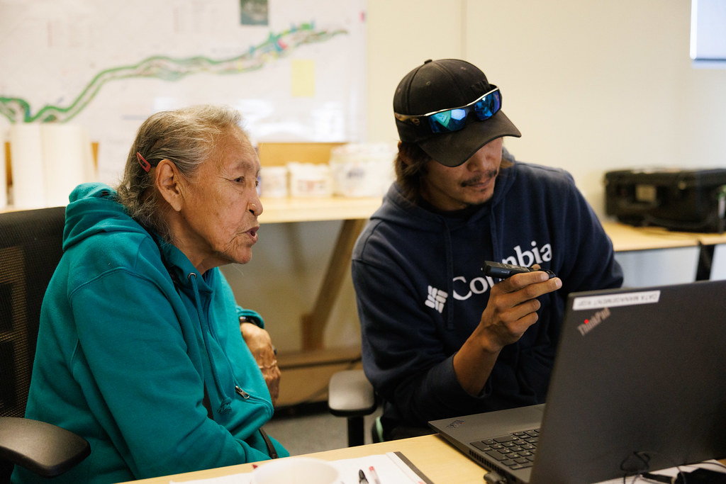 land_guardians's tweet photo. This is what “community impact” can look like. 
An Elder sharing traditional ecological knowledge in their language.
And a Guardian listening, taking notes, making sure that knowledge stays alive. 

Guardians' programs create space for many activities that contribute to cultural wellbeing: cultural camps, traditional harvesting, reports in their traditional language or constructing a community cabin to encourage land-based learning and connection to places that hold deep meaning for communities.🪶
