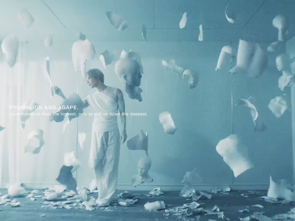 6v6kkoongs's tweet photo. This new post from the FLOAT MV director tells us so much more about the concept of the MV! 
"𝐿𝑜𝑣𝑒 𝑚𝑎𝑘𝑒𝑠 𝑢𝑠 𝑓𝑙𝑜𝑎𝑡 𝑡ℎ𝑒 ℎ𝑖𝑔ℎ𝑒𝑠𝑡, 𝑜𝑛𝑙𝑦 𝑡𝑜 𝑝𝑢𝑙𝑙 𝑢𝑠 𝑑𝑜𝑤𝑛 𝑡ℎ𝑒 𝑑𝑒𝑒𝑝𝑒𝑠𝑡"

In Greek mythology, 𝗣𝘆𝗴𝗺𝗮𝗹𝗶𝗼𝗻 was a sculptor who fell in love with a statue he carved. That statue was perfect and flawless compared to real humans. He treated it as a real person and companion giving it gifts, dressing it, treating it as a lover and eventually trying to kiss it. 
Goddess Aphrodite having heard his prayers brought that statue to life. He named her Galatea. 

And this is where it gets even deeper! 

𝗔𝗴𝗮𝗽𝗲 comes from the Greek αγάπη (love). It is a selfless and unconditional form of love. Agape is a more self-sacrificial kind of love that isn't dependent on receiving something in return. It doesn't require possession, it's about giving to the other person and caring for them. It is deliberate and expressed through actions.  

So if Pygmalion represents love born from an ideal, Agape represents the opposite which is loving beyond the ideal.

The Pygmalion myth isn't just about falling in love with a beautiful creation. It's also about the relationship between the artist and their work and how this love can blur the boundaries between art and life. 
Once the ideal you fell in love with becomes real, it becomes something more. It becomes a person of its own, with their own flaws and imperfections.

FLOAT talks about feeling weightless in love. "Every conversation seems to flow", "this is the greatest story ever told". But the MV keeps showing us that behind this pure, perfect (white) image there can be something unsettling (black). The thing that makes you float the highest can also pull you down the deepest.

And this is the 𝗼𝘅𝘆𝗺𝗼𝗿𝗼𝗻 Soft Violence is about.