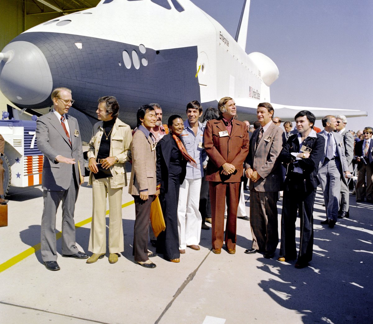 NASAhistory's tweet photo. These are the voyages of the Space Shuttle Enterprise!

50 years ago today, NASA's first space shuttle voyaged out of the Rockwell facility in Palmdale for its public unveiling! Hundreds of invited guests, including Star Trek creator Gene Roddenberry and several members of the Star Trek original series cast joined in the first orbiter's rollout celebrations. 

NASA had originally planned for the orbiter to be named Constitution and scheduled for the rollout for Constitution Day. But President Gerald Ford, after receiving letters from thousands of Trekkies, directed NASA to name the shuttle Enterprise after the fictional starship.