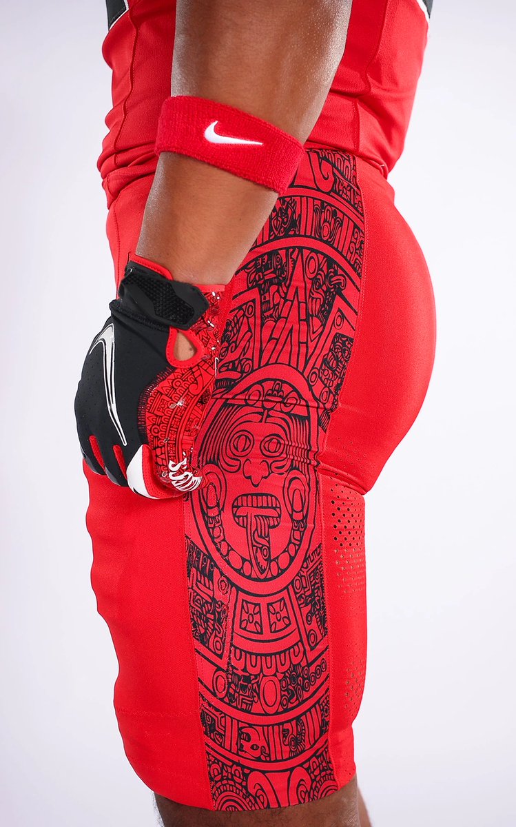 ZachCohenFB's tweet photo. Oh YEAH, job well done by San Diego State!🔥 

Pics & descriptions of their new “Age of the Jaguar” design, per their website:

“The uniform brings together SDSU’s signature red and black palette with a deeper story of strength, courage and identity. The look is anchored by a black helmet, featuring the Ocelotl glyph on one side and the player number on the other.

The Ocelotl mark connects the design to the jaguar’s historic symbolism: power, valor, and military prowess, and linked to health, grit, and perseverance. In Aztec tradition, Ocelotl represents Tezcatlipoca, god of the night sky, memory, and time. The jaguar also represents elite warriors who embodied discipline, bravery, and strength in battle.

“The Age of the Jaguar” extends the Glyphs iconography introduced last year, bringing that visual language from brand storytelling into the on-field uniform system. The Ocelotl glyph is the centerpiece of the helmet, while the custom sublimated artwork on the jersey sleeves and pant side panels carries the same sense of cultural texture throughout the full look.

Together, the uniform is designed to be bold from a distance and meaningful up close. It honors cultural symbolism, reflects San Diego State’s visual identity, and creates a modern on-field expression of confidence, strength, and competitive edge.”